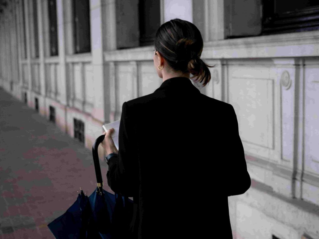 Mujer con paraguas caminando sola.